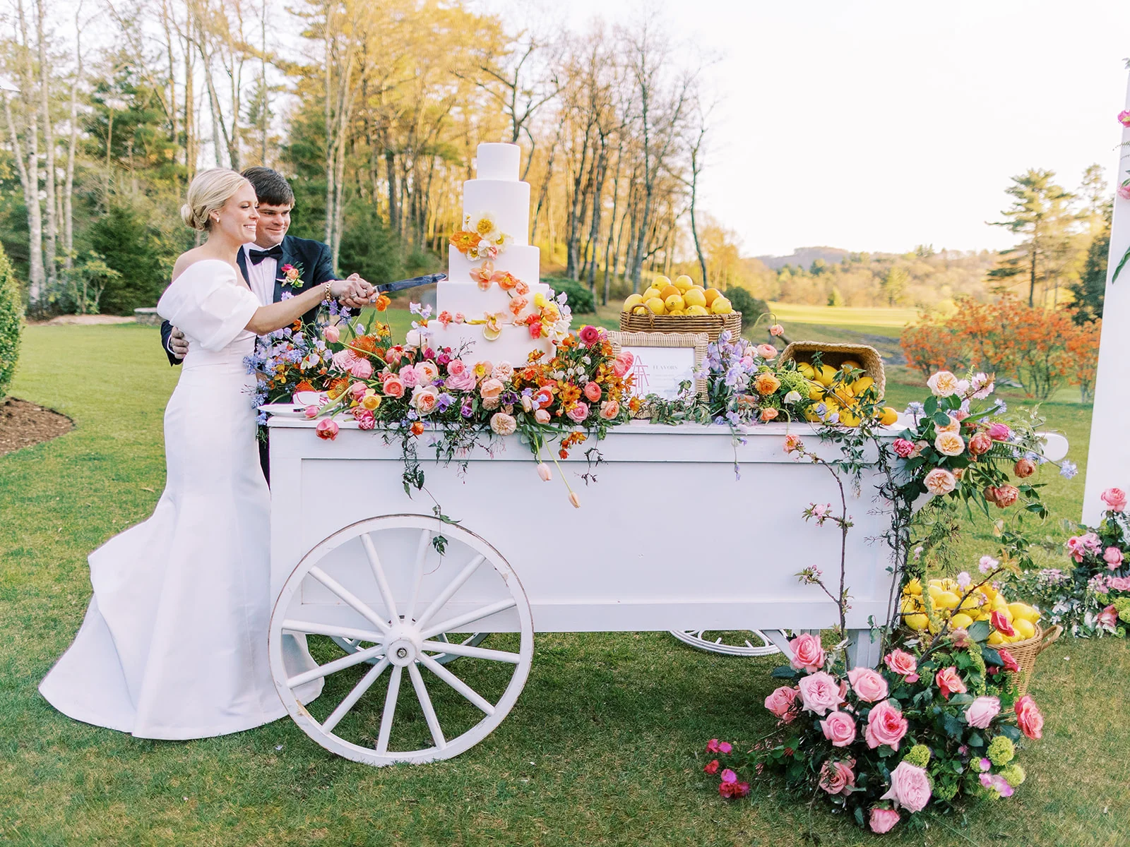 A floral display cart at an outdoor wedding reception