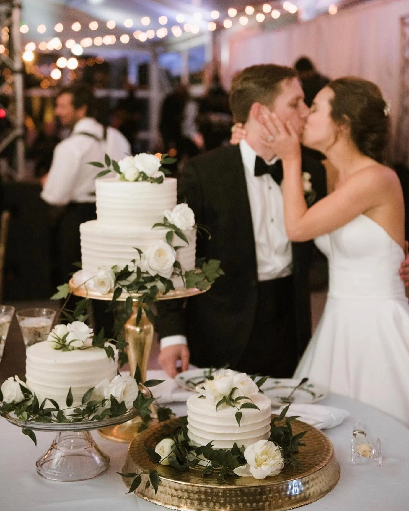 A groom’s cake alongside a wedding cake display