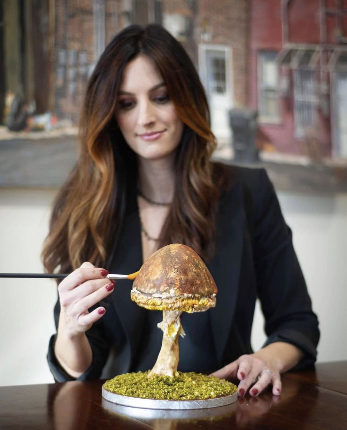 A hyper-realistic sculpted cake by Bonne Bedingfield, presented as a gallery plate.